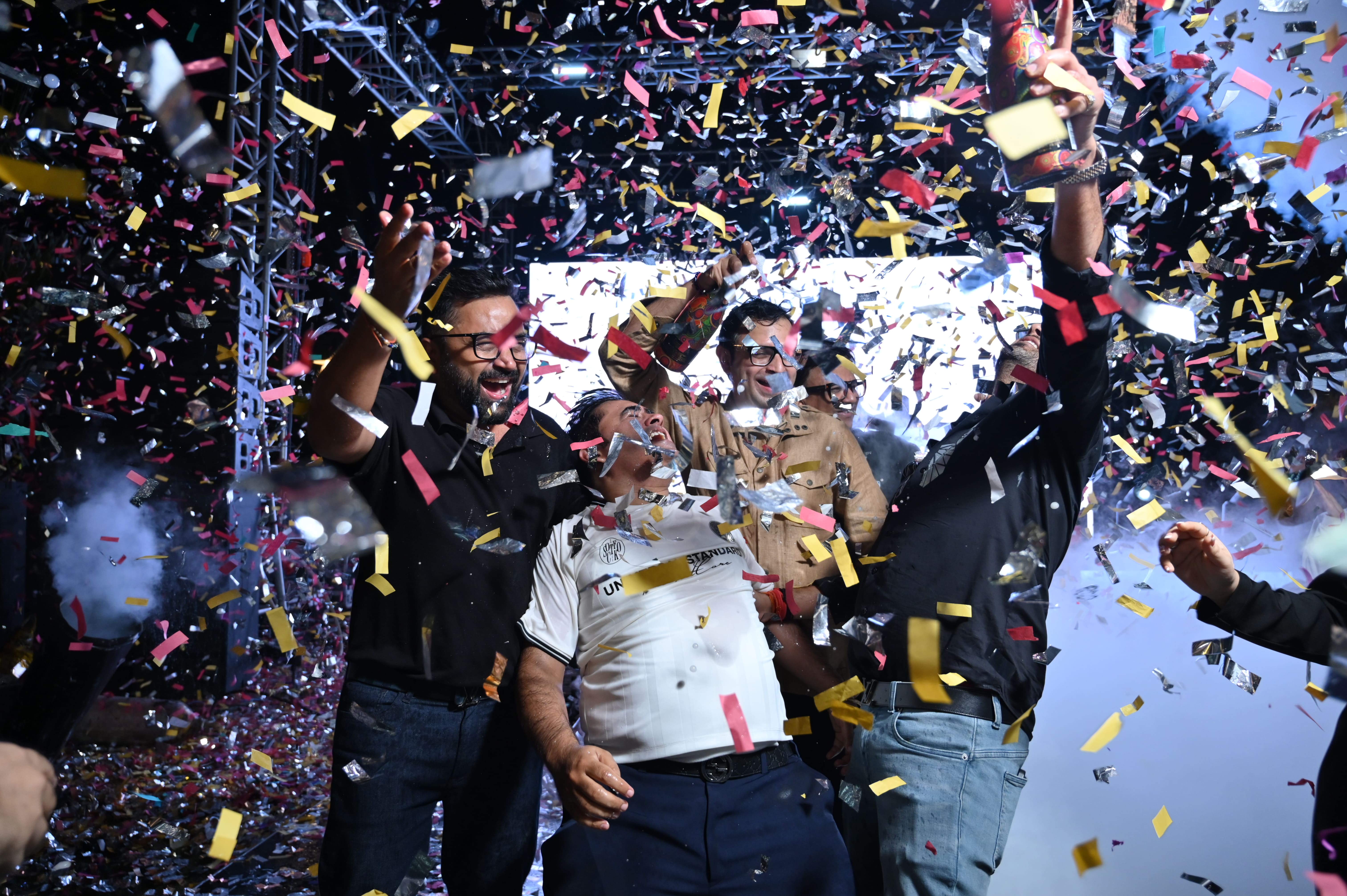 Lively celebration with confetti and stage lights in Greater Noida