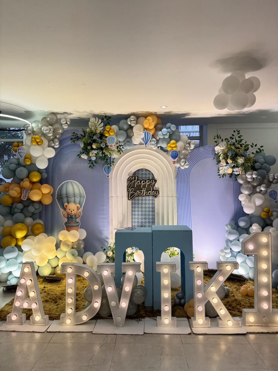 Hot air balloon themed first birthday backdrop with balloon garlands in Greater Noida